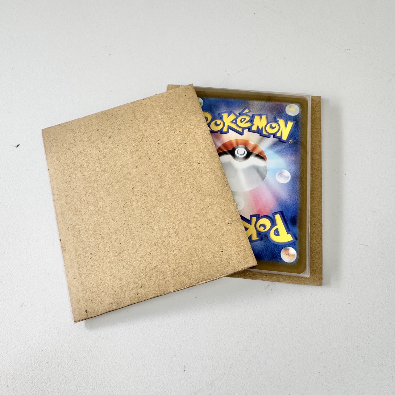 Rigid chipboard panels sandwich the cards to
                    stop bending.